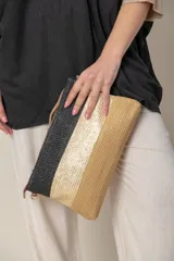 Sobre de mano de rafia color beige con diseño de franjas horizontales en tonos naturales. Incluye lazo de mano y correa desmontable para colgar.