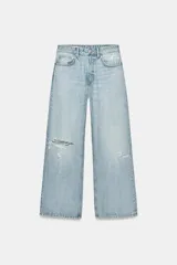 Jeans boyfriend de tiro medio con cinco bolsillos, diseño holgado y roturas decorativas en la parte delantera. Cierre frontal con cremallera y botón metálico.