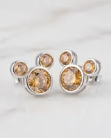 Aros abridores plateados con diseño de la silueta de Mickey Mouse, engastados con circonias color ámbar.