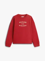 Buzo de cuello redondo confeccionado en tejido de felpa, con diseño de corte holgado y mangas largas. Presenta un estampado frontal con la inscripción HILFIGER N.Y.C. MCMLXXXV en color blanco.