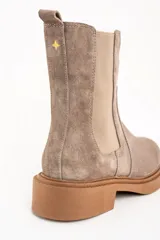 Bota Chelsea de gamuza color visón, con elásticos laterales y suela de goma color caramelo.