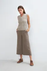 Chaleco de lana color crudo, tejido con escote en V y diseño con diferentes puntos combinados en el frente.