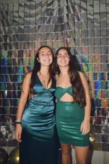 Vestido corto ajustado con acabado brillante, color rojo metálico. Presenta un escote halter con tiras cruzadas y un corte cut-out en la zona del abdomen.