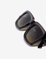 Lentes de sol unisex Hawkers con montura rectangular color gris translúcido y lentes degradadas de gris a verde.