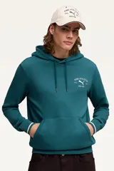 Canguro Puma modelo Class Graphic Hoodie, color crudo con capucha y bolsillo tipo canguro. Presenta un estampado en la espalda con el logo de la marca y la inscripción "Puma Athletics Since 1948".