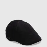 Boina de estilo clásico confeccionada en tela de corduroy negro, con diseño de paneles y ojales metálicos laterales para ventilación.