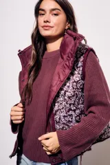 Chaleco bordeaux con interior estampado floral, de corte al cuerpo y cierre frontal con cremallera.