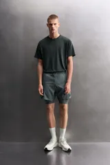 Pantalones cortos de entrenamiento 2 en 1 de Zara Athleticz, confeccionados en tejido técnico ligero y elástico. Presentan una malla interior integrada, cintura elástica con cordón ajustable, bolsillos laterales con cierre y aberturas en el bajo.