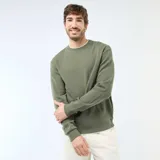 Buzo de cuello redondo verde con textura tipo nido de abeja, mangas largas y puños elastizados.
