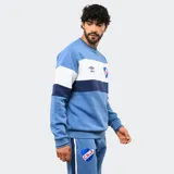 Buzo de felpa Umbro del Club Nacional de Football, con diseño de bloques de color en azul, rojo y blanco. Presenta cuello redondo, puños y ruedo acanalados, con el logo de la marca y el escudo del club bordados en el pecho.