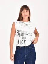 Remera blanca sin mangas con hombreras, estampado de texto de periódico en gris y la frase "DO IT FOR THE PLOT" en negro.