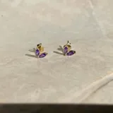 Par de aros dorados con tres piedras de color amatista en forma de lágrima.