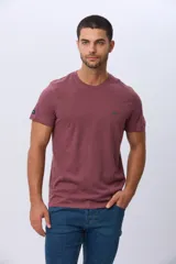 Remera básica de manga corta con cuello redondo, confeccionada en tejido de algodón. Presenta un pequeño logo bordado en el pecho.
