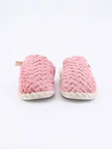 Pantuflas cerradas color negro con textura afelpada y borde trenzado color beige.