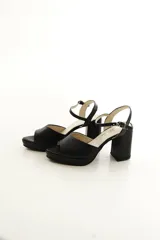 Sandalias de taco grueso y plataforma delantera, confeccionadas en cuero vacuno color dorado con tira en la parte frontal y correa ajustable al tobillo.