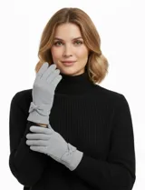 Guantes de tejido soft color beige, con un pequeño lazo decorativo en la muñeca.