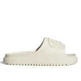 Sandalias Adidas modelo Campus 00S Foam Slide, color blanco, con diseño deslizante de una sola tira con el logo en relieve y suela dentada.
