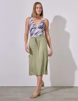 Falda midi color verde militar, de corte recto, con pretina ancha elastizada y lazo de ajuste. Presenta bolsillos cargo laterales.