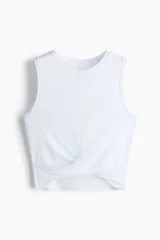 Top cropped de pilates color blanco, de corte ajustado, con cuello redondo, sin mangas y detalle girado en el bajo. Confeccionado en suave punto de modal.