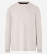 Buzo de algodón y poliéster color beige, con cuello redondo, mangas largas y puños ajustados. Diseño liso y minimalista.