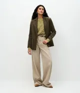 Suéter de punto con textura jaspeada, cuello redondo y mangas largas amplias con puños ajustados. Presenta un corte regular y diseño versátil.