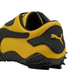 Championes Puma modelo Mostro OG Prime, color amarillo con detalles en negro. Presentan un diseño distintivo con suela de goma con relieve de tachones, cierre de velcro y la icónica franja lateral de la marca.