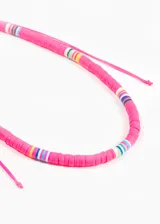 Collar corto de mostacillas de látex color celeste con detalles de mostacillas de colores.