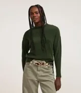 Suéter de punto texturizado con cuello redondo y mangas largas con sisa caída. Presenta un diseño liso y holgado, ideal para un estilo casual y versátil.