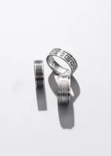 Anillo plateado de acero quirúrgico con tres ranuras que permiten que la parte central gire.