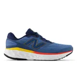 Championes de running New Balance Fresh Foam X Evoz V4, color azul con detalles en azul marino, amarillo y rojo.