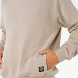 Canguro de algodón color beige con capucha, mangas raglán y bolsillo frontal tipo canguro. Presenta un pequeño parche con el logo de la marca en la parte inferior.