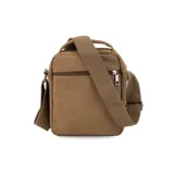 Morral de tela canvas color verde oliva, con correa regulable y asa de mano. Tiene dos bolsillos frontales con cierre, llavero exterior, bolsillos internos y bolsillo trasero con cierre.