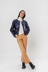 Bomber azul marino de cuero con mangas ranglán, bolsillos laterales, elástico en la cintura y cierre metálico delantero.