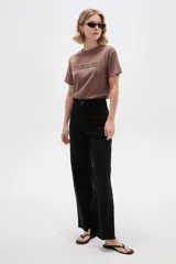 Pantalón jean negro de tiro alto y corte ancho.
