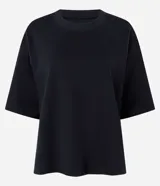 Remera oversize blanca de manga corta, con cuello redondo y diseño holgado, confeccionada en mezcla de algodón y poliéster.