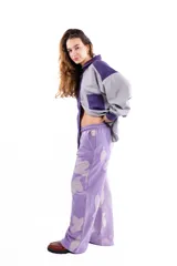 Pantalón de pierna ancha con estampado floral en tonos violeta y lila. Presenta una pretina elástica con cordón ajustable, bolsillos laterales y un diseño de corte holgado.