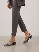Zapatos slingback de cuero color gris metalizado, con punta cuadrada, taco ancho bajo y tira ajustable con hebilla en el empeine.