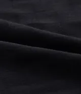 Vestido midi de jacquard color negro, con escote en V y cordón ajustable en la cintura. Presenta mangas cortas de estilo holgado y una textura sutil en el tejido de viscosa.