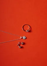 Cadena de eslabones tipo forcé con dije en forma de corazón, compuesto por una piedra central de zirconia rodeada por un marco de pequeñas circonias engastadas.