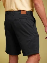 Bermuda de gabardina color negro, de corte clásico y diseño liso con bolsillos laterales.
