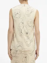 Remera de tirantes color crema con estampado de flores negras, cuello redondo y corte recto.