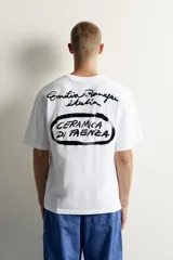 Remera de corte relaxed fit, color blanco, con cuello redondo y manga corta. Presenta un pequeño estampado en contraste en el pecho.