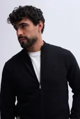 Campera de tejido liviano de punto, color negro, con cierre frontal, cuello alto, mangas largas y puños ajustados, con detalle de logo bordado en el pecho.