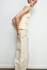 Pantalón cargo de tiro medio confeccionado en algodón, con cintura con trabillas, bolsillos delanteros y bolsillo de plastrón con solapa en la pierna.