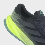 Championes de running Adidas Supernova Rise 2 para hombre, color negro con malla en la parte superior y detalles en verde lima fluorescente en la entresuela Dreamstrike+. La suela exterior es de color azul claro.