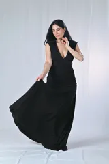 Vestido largo negro con escote en V profundo y bordado con lentejuelas en el escote. Corte ajustado en la cintura y falda larga con caída fluida.