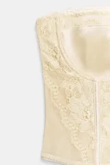 Corsé con aros y escote corazón, confeccionado en tejido tipo tul con aplicaciones de encaje a tono.