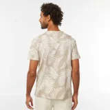 Remera de manga corta color beige con estampado de hojas de palmera blancas. Corte clásico y cuello redondo.