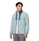 Buzo polar con cierre frontal completo de la marca Columbia. Presenta un diseño en color azul claro con paneles superpuestos en un tono azul más oscuro en la zona del pecho y cuello. Incluye bolsillos laterales con cierre, cuello alto y detalles en color amarillo neón en los tiradores de los cierres.