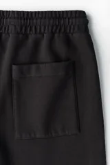 Short de felpa de mezcla de algodón en color negro, con corte regular fit, cintura elástica con cordón de ajuste y bolsillos laterales. Presenta franjas laterales blancas con el logotipo de la marca repetido y el logo de Lotto bordado en la pierna izquierda.